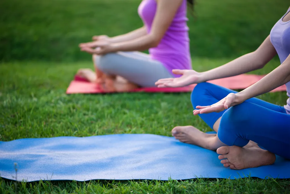 Group practicing meditation outdoors